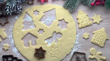 Baker adding christmas cookie cutters to dough video