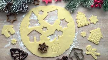 Baker adding christmas cookie cutters to dough video