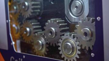 Mechanism with rotating gears. Media. Shiny metal gears rotate in moving mechanism. Industrial mechanism with rotating gears video