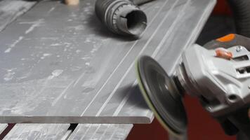Process of grinding raw wood plank with angle grinder in workshop. Creative. Flying wood dust while polishing timber surface. video
