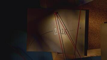 Night office with notes. Stock footage. Light of lantern illuminates inscriptions on stickers with strings in night office. Mysterious stickers with rebus values video