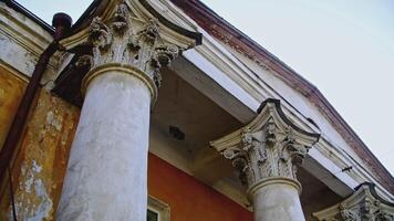 Building residence facade in classical style of architecture. Stock footage. Low angle view of old facade of a building with columns. video