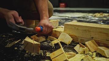 Carpentry works, carving wood block. Media. Using chisel for processing timber bar while assembling stage decorations. video
