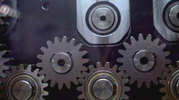 Mechanism with rotating gears. Media. Shiny metal gears rotate in moving mechanism. Industrial mechanism with rotating gears video