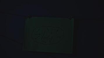 Mysterious notes in night office. Stock footage. Rebus notes are illuminated in night office. Mysterious notes with inscriptions and red thread in night room video