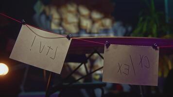 Mysterious notes on threads. Stock footage. Mysterious rebus on notes suspended by threads in office. Close-up of inscriptions on notes with threads video