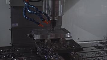 Automated drill on industrial machine. Media. Robotic machine with drill to drill holes in metal. Machine with drill rotates and holes metal plates video