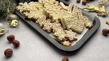 Christmas cookies with white icing displayed on a black baking sheet video