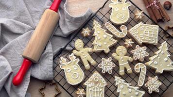 Christmas cookies cooling on a rack, with a rolling pin and cookie cutters in the background video