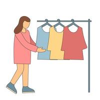 A woman is holding a rack of clothes vector