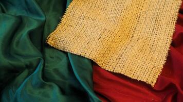 A rustic vintage burlap featuring green and red plain fabric, copy space for minimalist christmas greeting design textured background photo