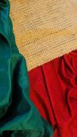 A rustic vintage burlap featuring green and red plain fabric, copy space for minimalist christmas greeting design textured background photo