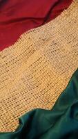 A rustic vintage burlap featuring green and red plain fabric, copy space for minimalist christmas greeting design textured background photo