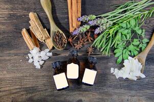 bottles of aromatic oils on rustic background photo