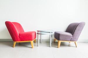 Two chairs and table in a room with white walls photo