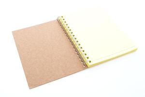 A notebook with a spiral bound cover and a yellow notepad photo