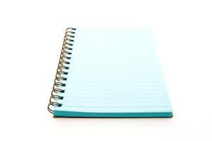A spiral notebook with blue pages on a white background photo