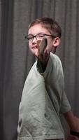 vertical boy knight hits with a sword. The boy attacks with a wooden sword. A boy with glasses plays knight, warrior with a sword. video