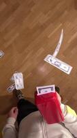 vertical pov first person view Man shooting fake money with a toy gun. A man throws hundred dollar bills. Man having fun shooting fake dollar bills with a toy money gun, causing cash to rain down video