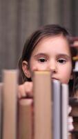 vertical Little Girl Child Choose Books on Shelf. Young Schoolgirl Taking Books From Shelf and Flipping Through Pages in Library. Book Reading Hobby. video