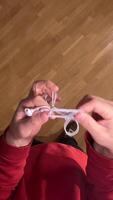 vertical wired headphones tied in a knot. Concept of annoying problem. Solution to the problem. Inconvenience of wired headphones video