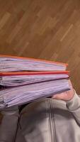 vertical pov First person view Student carrying heavy, colorful binders symbolizes the challenges of education and time management. Man busy with office paperwork. Hard office work concept video