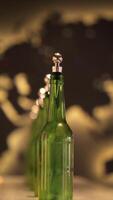 vertical Green bottles with silver caps and numbered wooden sticks are standing in a row in front of a blurred world map, possibly representing global beer or beverage industry video