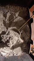 vertical Housekeeper scooping ashes from a fireplace prepares the space for a new fire. Removing debris ensures a clean and safe environment for cozy winter evenings video