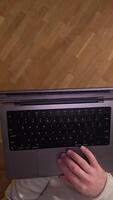 vertical POV first person view Man standing holding laptop on hand and scrolling internet page, surfing internet. modern tech enables efficient communication, capturing digital nomad lifestyle video