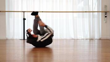 Professional dancer practices moves rotating on floor video