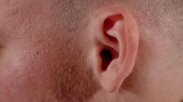 Bald head guy wiggles ears playing fool at bright light video