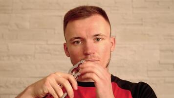 Serious man shows nutcracker and performs taking out tooth video