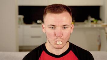 Bearded guy takes pacifier in mouth for fun and falls asleep video