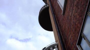 Building made of red bricks with wide round balcony closeup video
