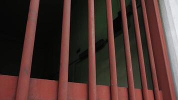 Large gate with lattice and bright red matt vertical bars video