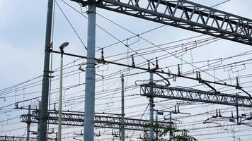 Diagonal and horizontal overhead power lines against sky video