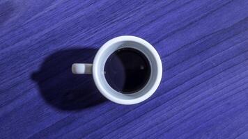 Porcelain coffee cup filling and emptying with dark liquid video