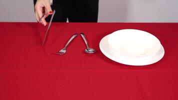 Person hands throw silver spoons fork and knife on table video