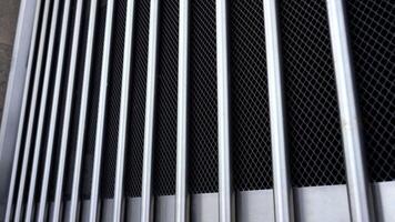 Large gate with lattice and bright metal matt vertical bars video