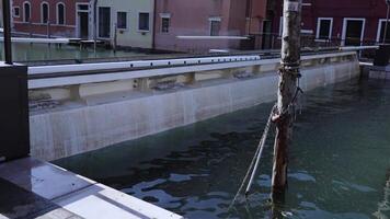 Canal rising dam at high water level after rain by buildings video