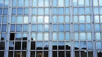 Dark building silhouette reflects in business center windows video