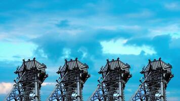 Towers with antennas stand against sky with floating clouds video