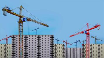 Clouds float in sky above buildings and cranes on sunny day video