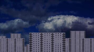Clouds above multi-storey buildings and day turns into night video