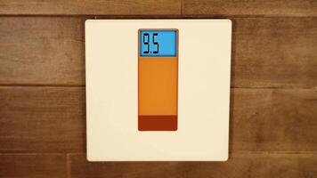 Electrical scales show running digits standing on floor video