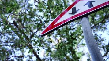 Old road sign Two way traffic in red triangle on grey pole video