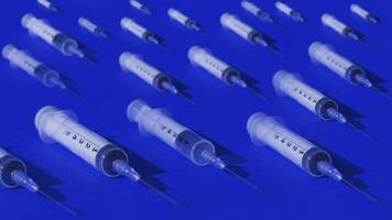 Syringes empty slowly lying on multi-colored background video