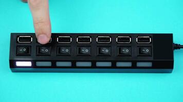 Finger presses buttons of black universal serial bus cord video