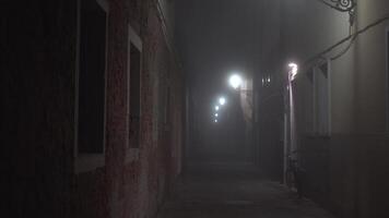 Bicycle stands near wall of building in illuminated alley video