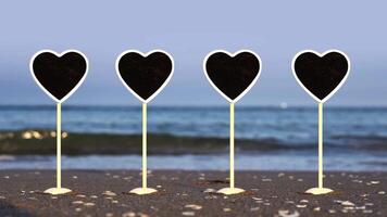 Line of heart shaped plates with space for template on beach video